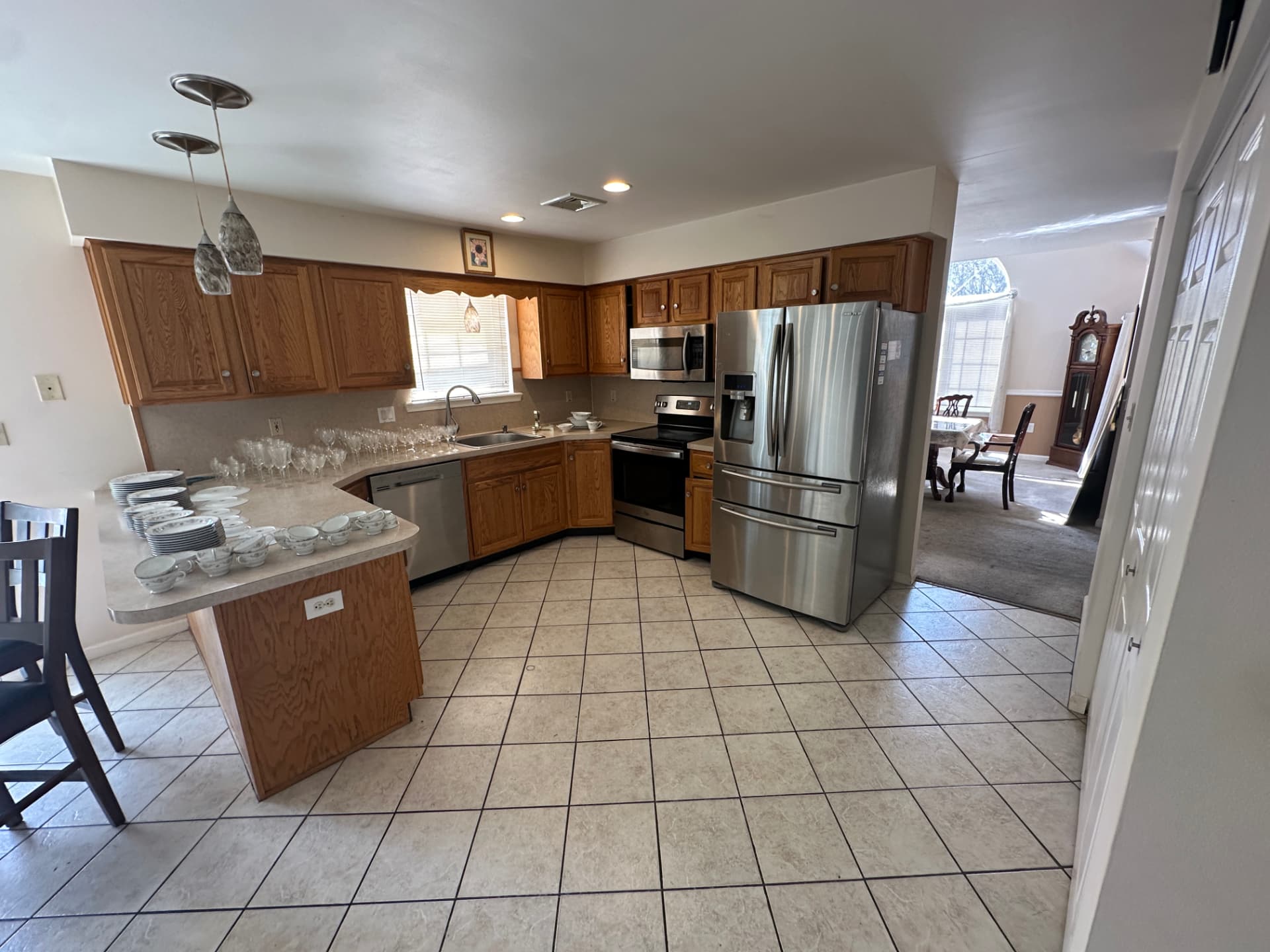 Kitchen with oak cabinets, stainless steel appliances, and a tile floor